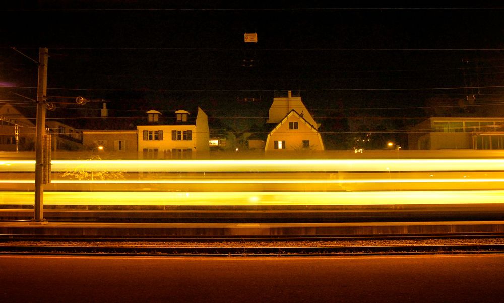 Un treno notturno attraversa una città